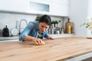 A woman with obsessive-compulsive disorder (OCD) cleans her kitchen cooktop to calm her nerves.