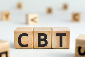 Image of wooden blocks with letters arranged to spell the acronym CBT, illustrating Cognitive Behavioral Therapy.