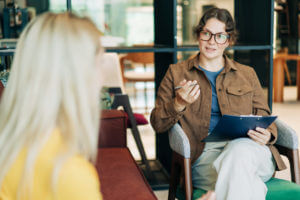 A female psychologist is conducting an ADHD diagnosis on an adult female patient.