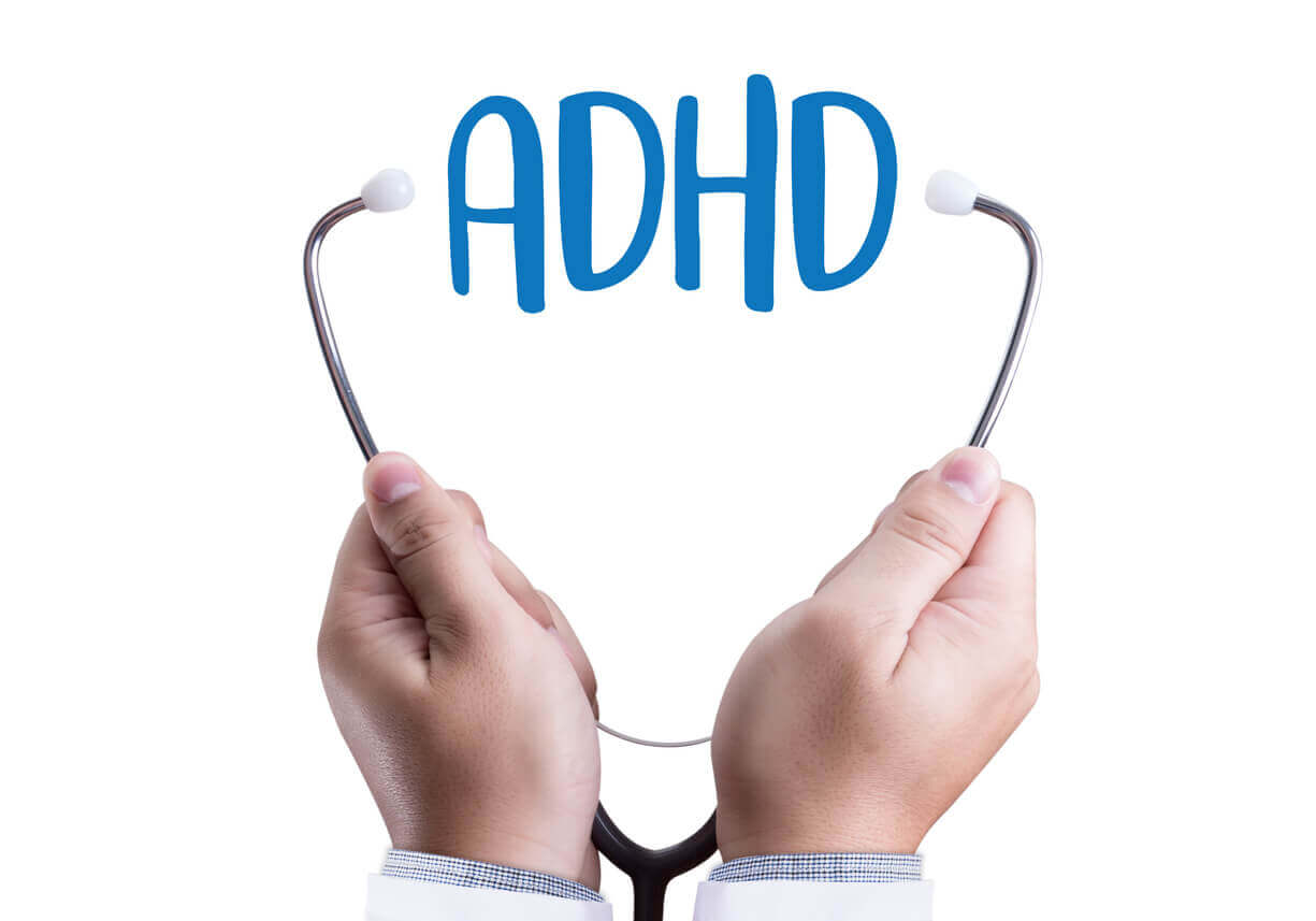 Image of ADHD text between a stethoscope representing the diagnosis of Attention Deficit Hyperactivity Disorder.