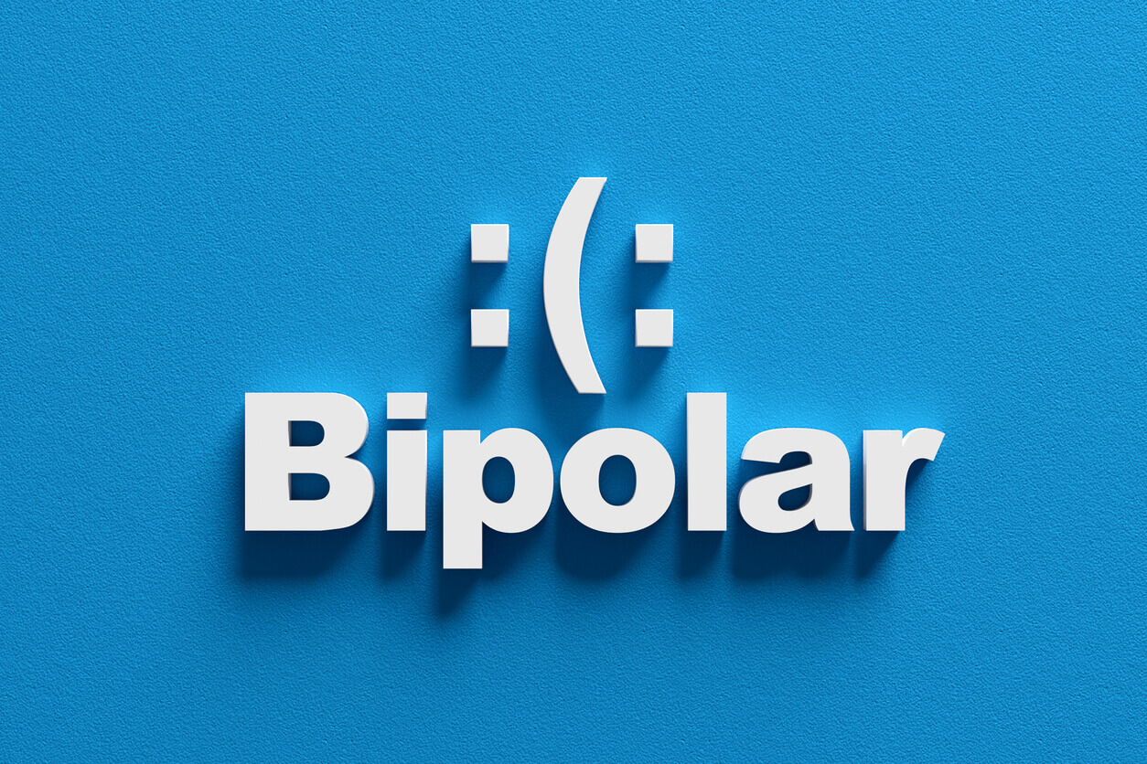 Bipolar disorder concept showing sad and happy moods.
