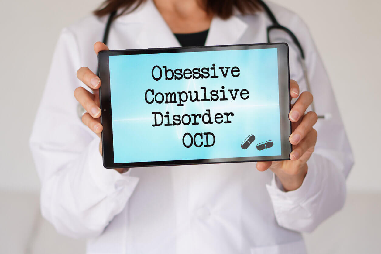 Female doctor with the diagnosis of obsessive-compulsive disorder (OCD) written on a digital tablet.
