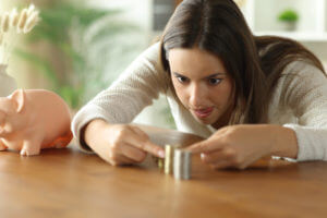 Obsessed woman relieving ocd aligning coins at home