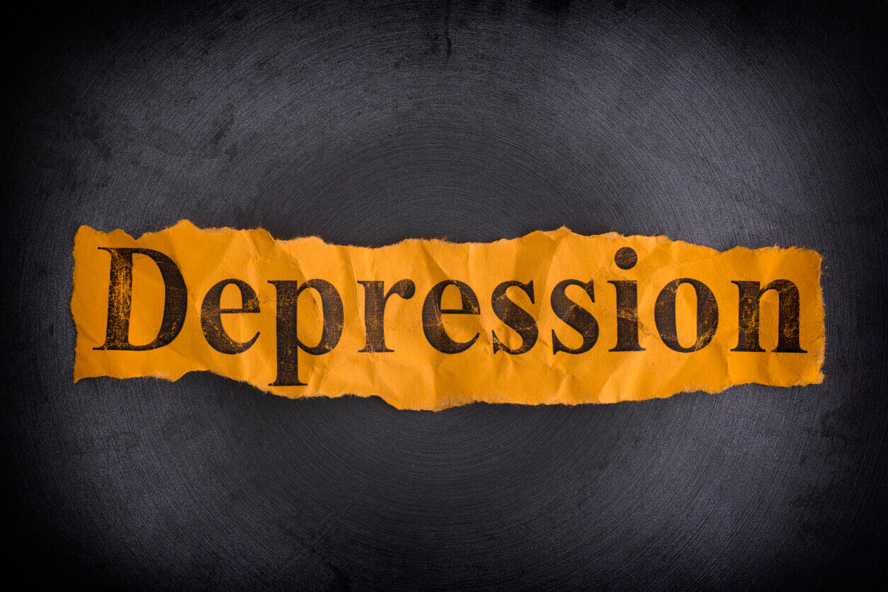 Torn crumpled piece of yellow paper with the word Depression